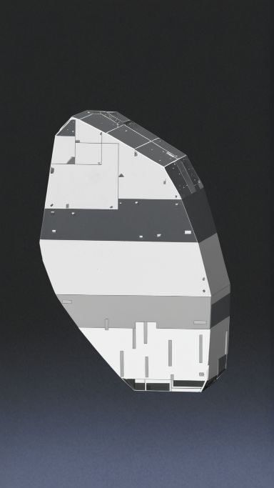 A faceted block rendered as flat panels in white, mid grey and charcoal, with small rectangular fittings, against a dark background that fades to slate blue.